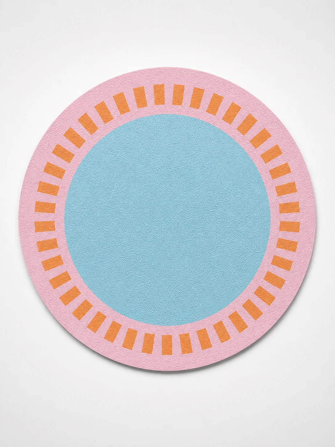 round faux leather placemat with a pink border, orange tick ring and sky-blue centre on a white background