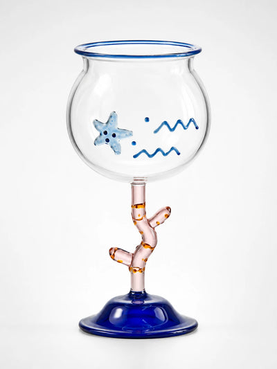 clear fishbowl cocktail glass with raised blue starfish and wave motifs, pink coral stem and cobalt blue bell foot