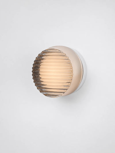 warm amber wall lamp mounted flush on a wall
