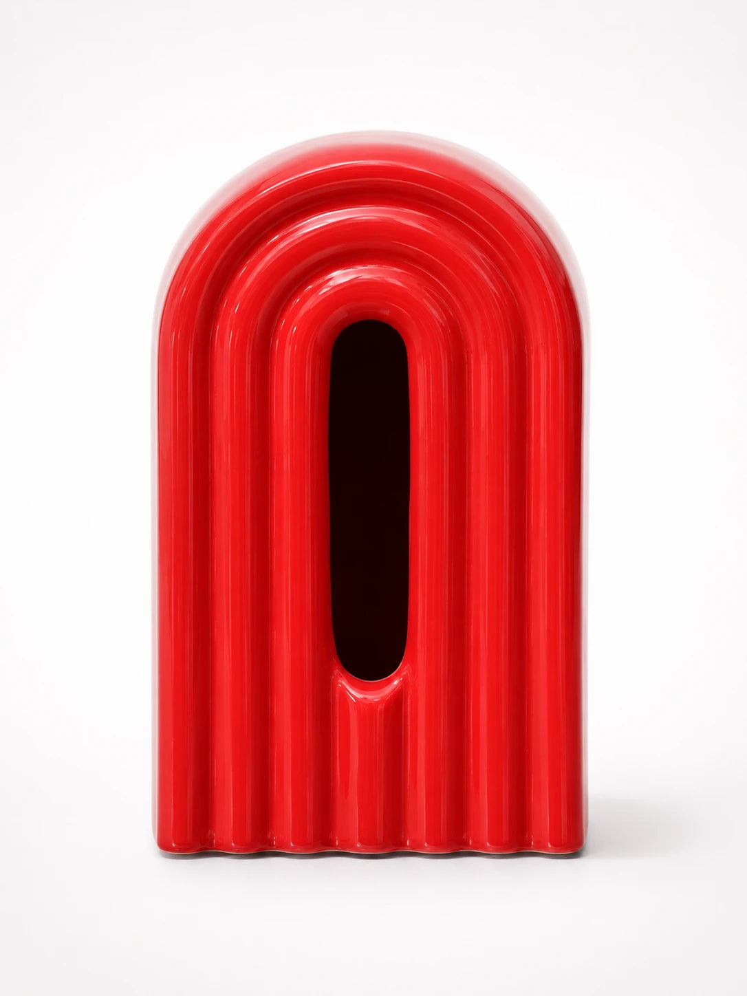 glossy red ribbed ceramic arch tissue box cover with dark oval front slot, studio shot