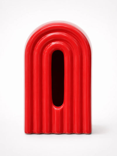 glossy red ribbed ceramic arch tissue box cover with dark oval front slot, studio shot