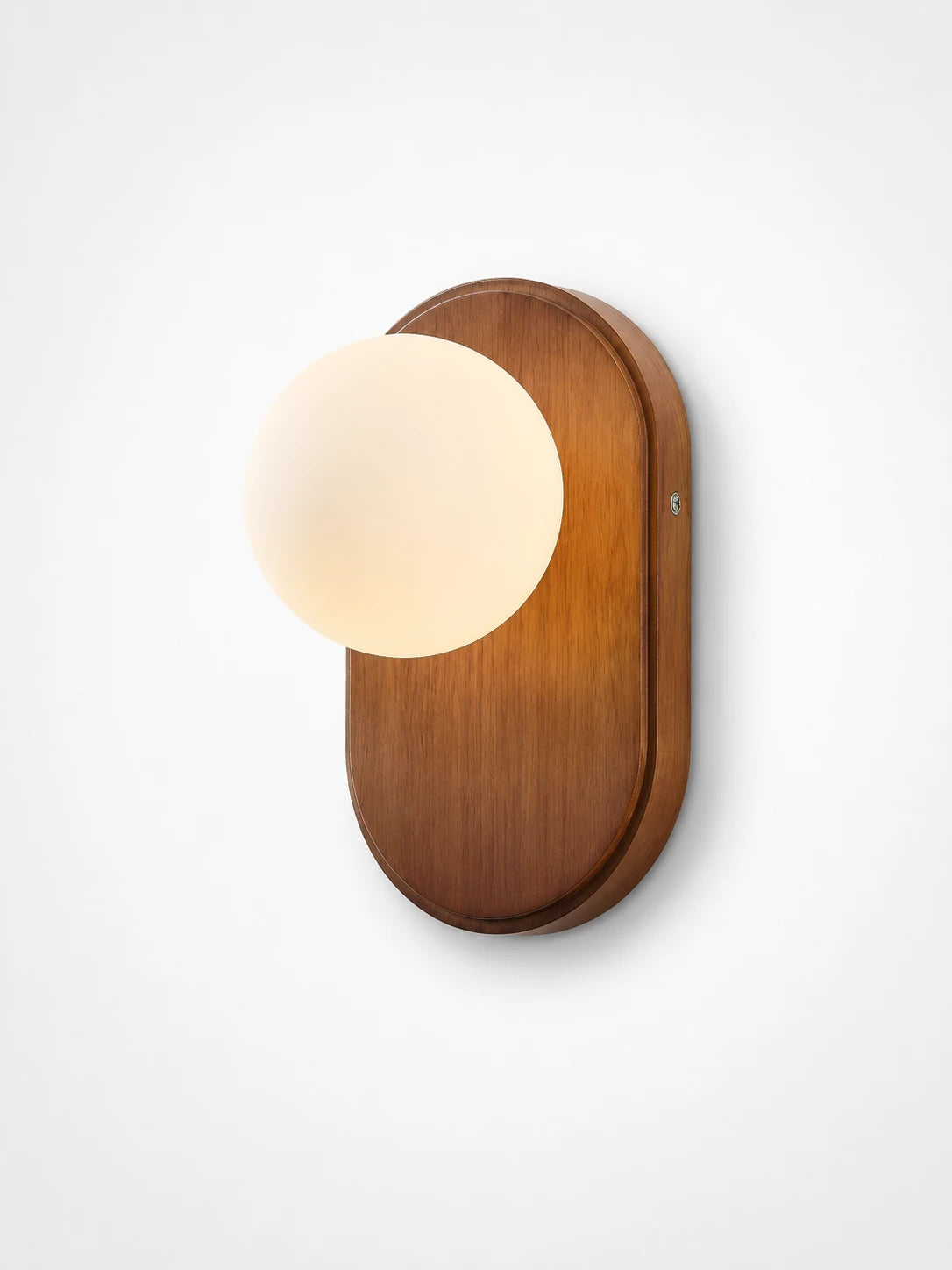 flush resin wall sconce glowing warm in a hallway