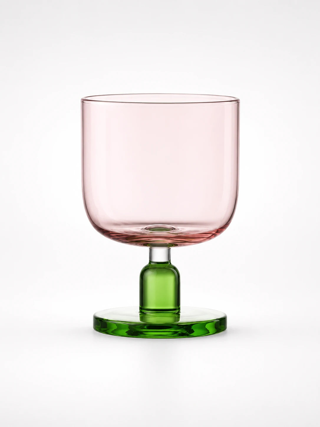 pink glass tumbler with a green stem and round base