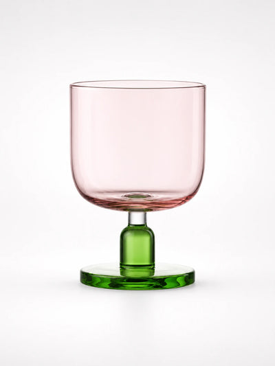 pink glass tumbler with a green stem and round base