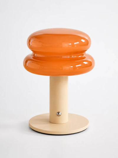 orange stacked macaron glass cordless lamp with cream stem and base on white background