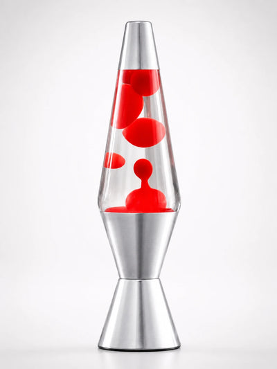 retro lava lamp with clear liquid and red wax blobs in a tapered glass body on a silver aluminum base