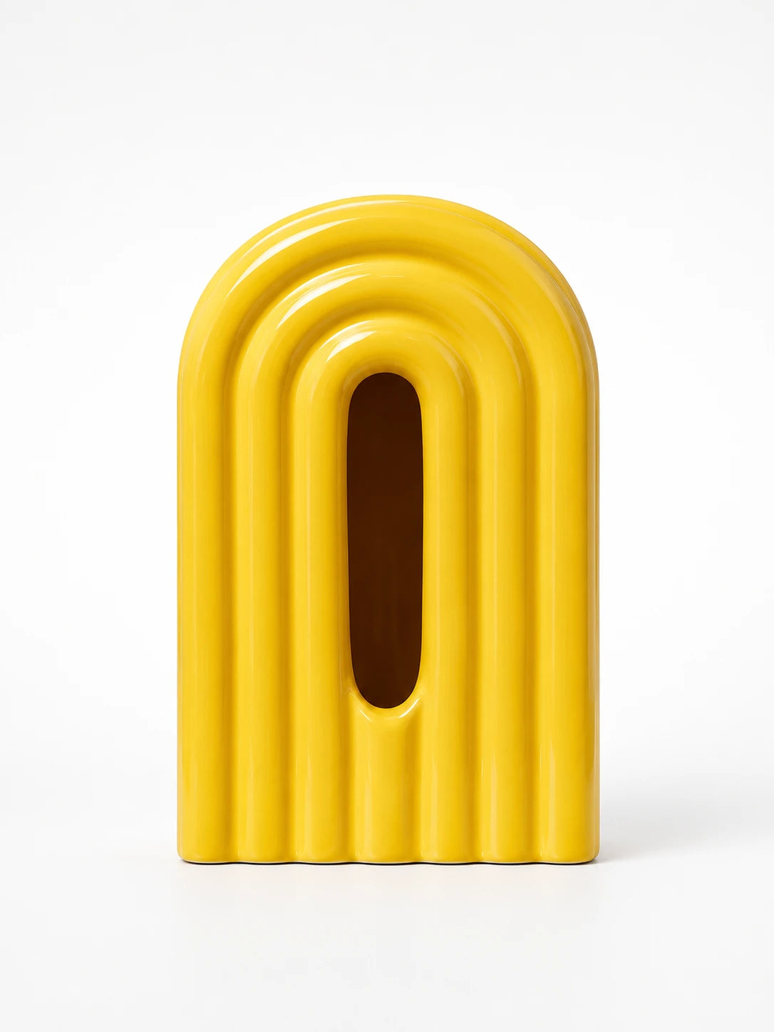bright yellow ceramic rainbow arch tissue box cover with front tissue slot on white background