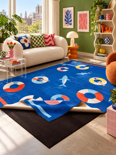 Pool party rug before a cream sofa against a green wall with checkered and wavy pillows and an orange stool