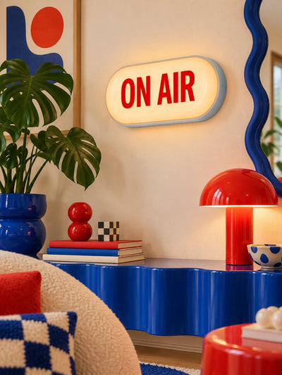 ON AIR capsule sign above a blue wavy console with red mushroom lamp and wavy mirror