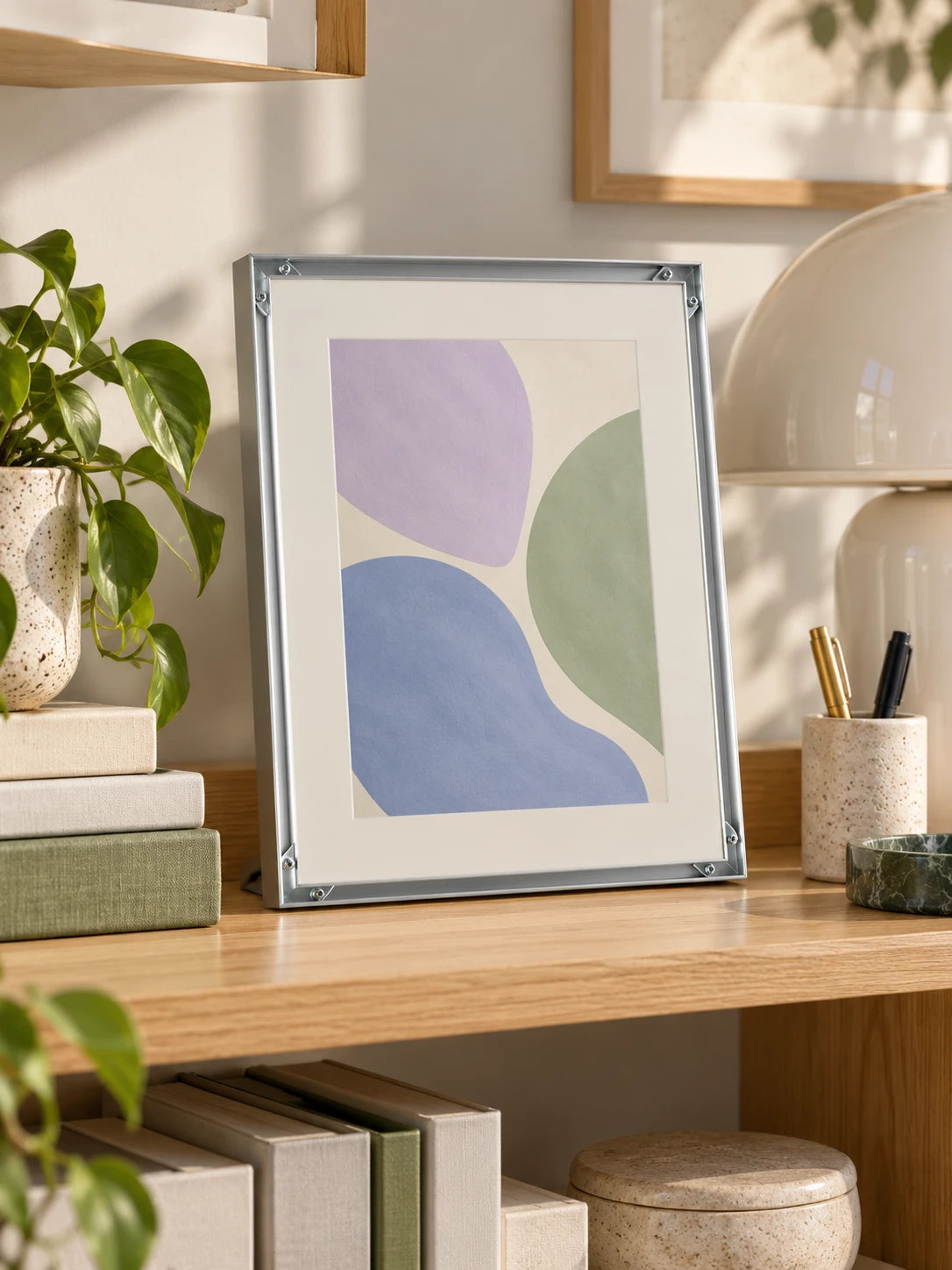 
silver aluminum poster frame with art print in a styled room scene
