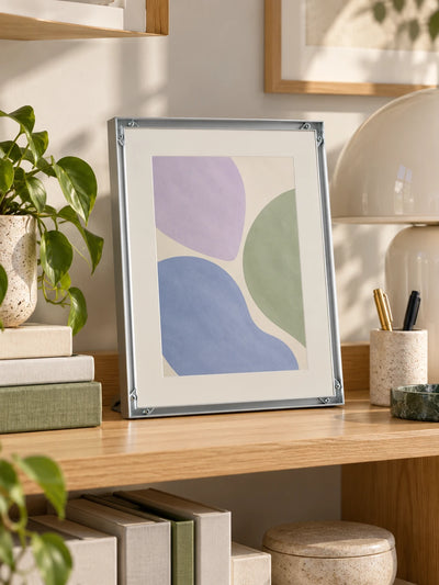 silver aluminum poster frame with art print in a styled room scene