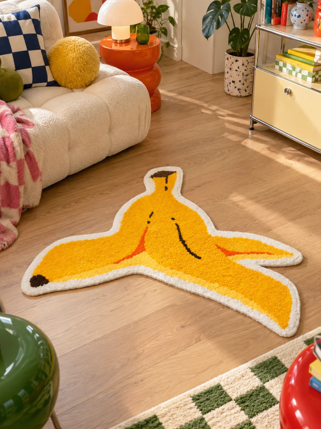 Banana peel mat beside a cream sofa with orange side table and yellow storage unit