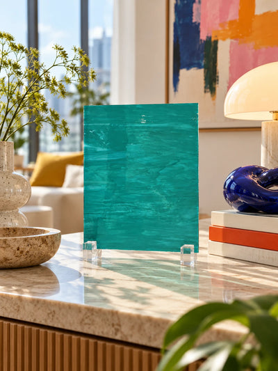 teal wisp glass sheet on a marble counter in a bright living room