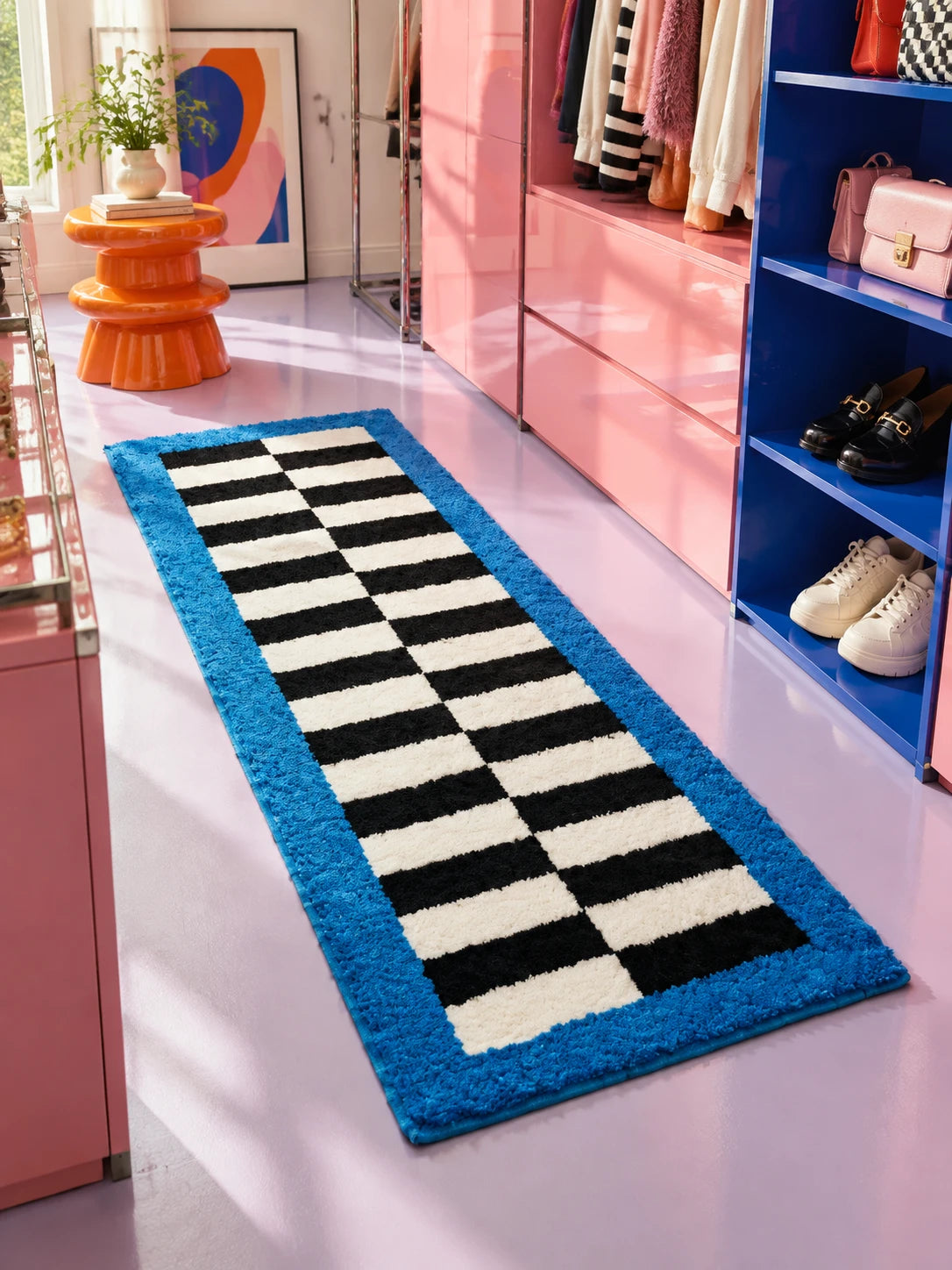 Checkerboard runner rug in a pink and cobalt walk-in closet with shoes on blue shelves