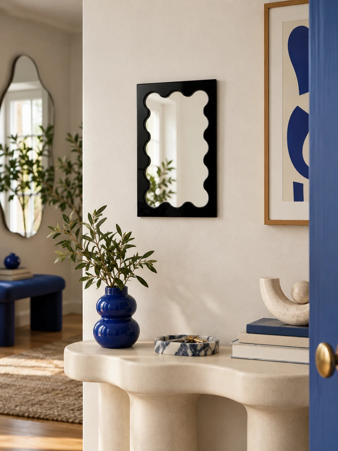 Black wavy vanity mirror against a colorful styled wall