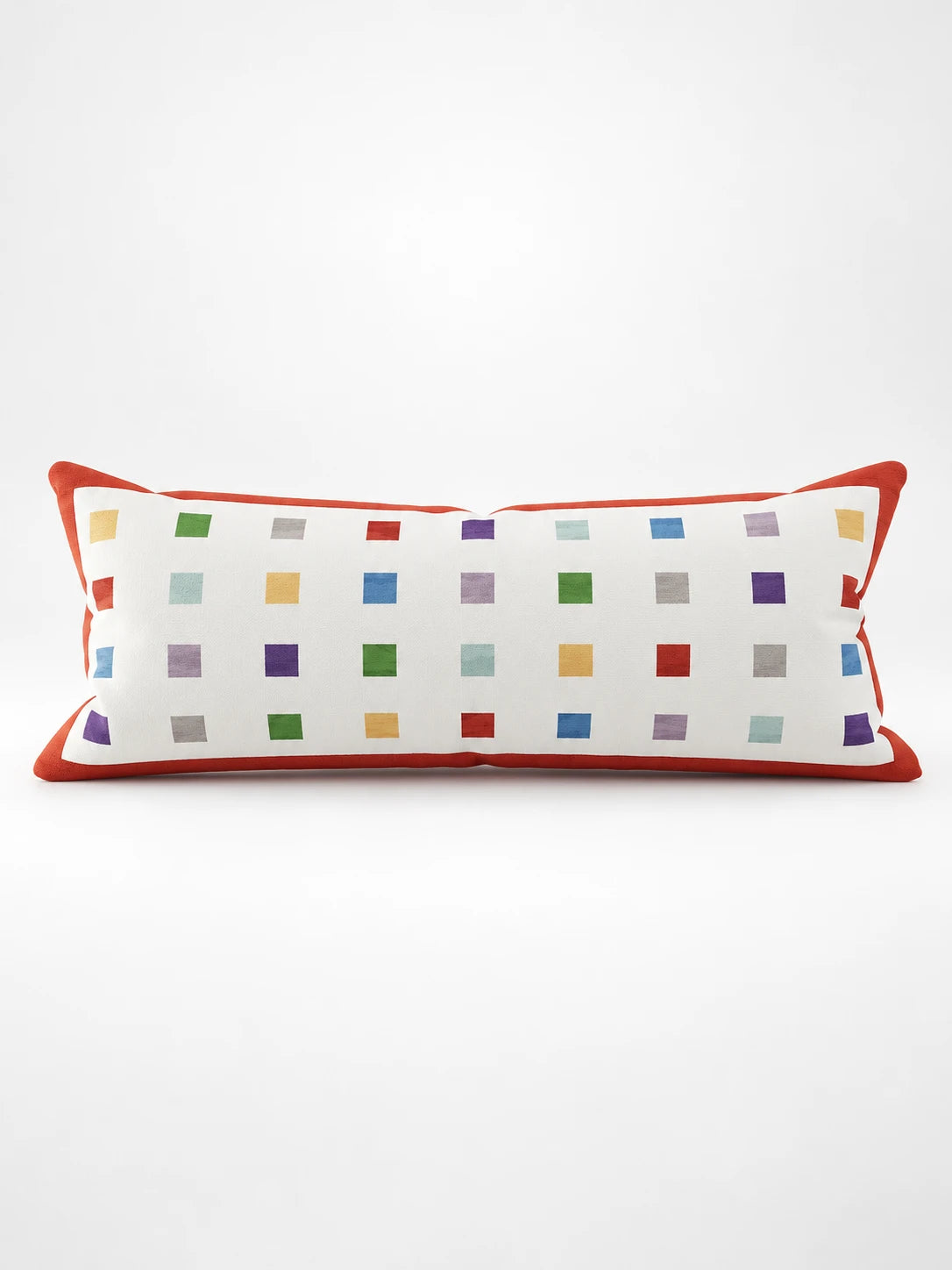 
White lumbar pillow with rows of small rainbow squares and an orange-red border, studio shot