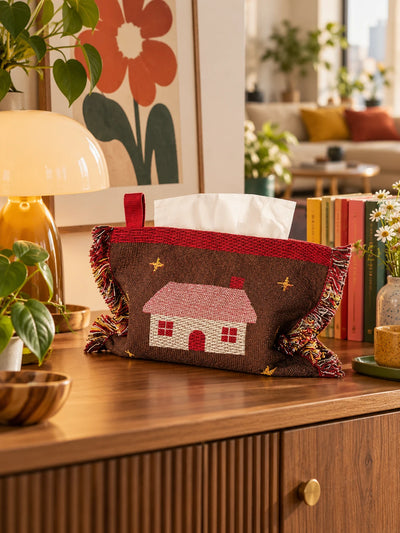 brown cabin knitted tissue pouch on a sideboard with flowers