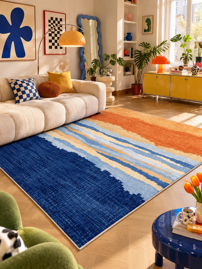 Blue and orange gradient rug in a living room with orange arc lamp and wavy blue mirror