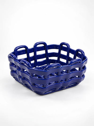 Ultramarine blue woven ceramic storage basket, studio shot