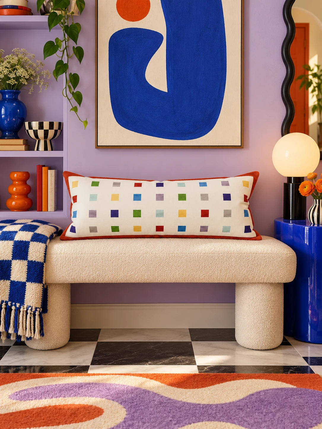 Rainbow squares lumbar pillow on a cream boucle bench in a lilac room with a cobalt abstract print