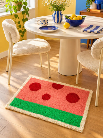 watermelon mat under a round dining table with two boucle chairs