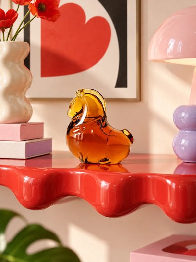 Glazed glass pony ornament styled in a tabletop vignette