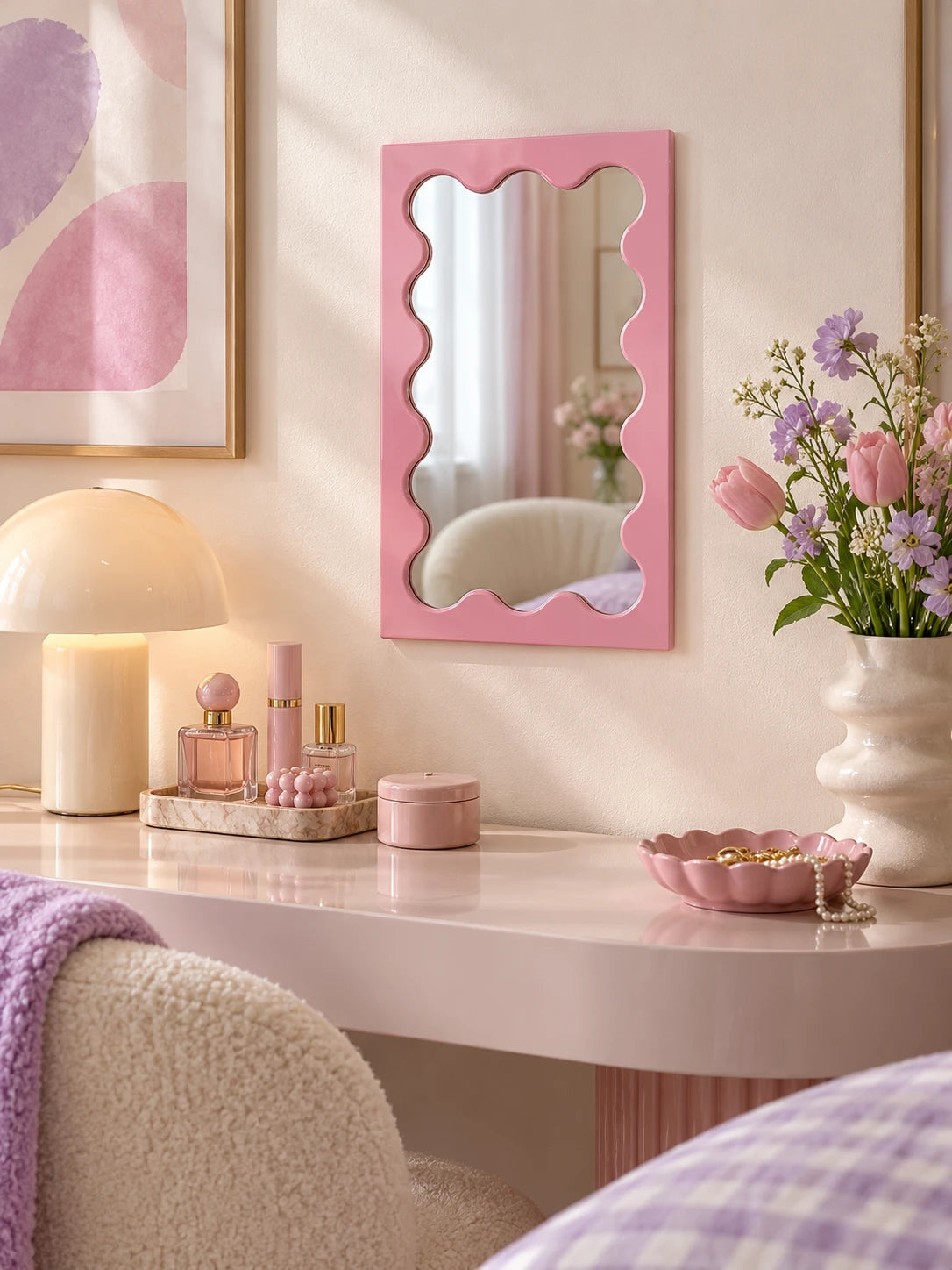 Pink wavy-frame vanity mirror in a pastel vanity nook