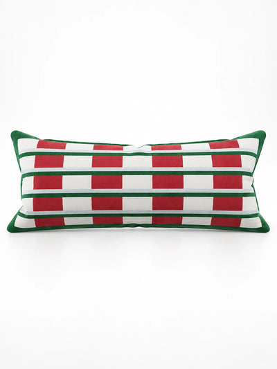 White lumbar pillow with red blocks crossed by green and pale blue stripes and a green border