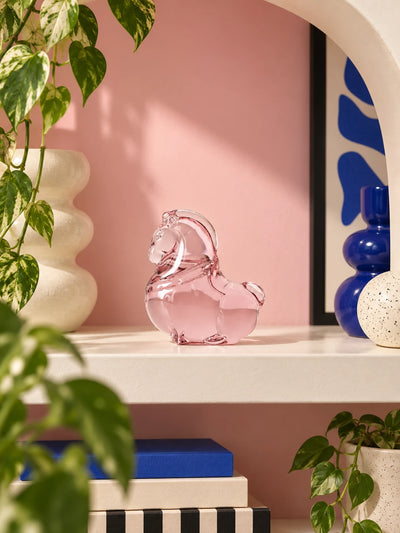 Glazed pony ornament displayed in a colorful decor arrangement