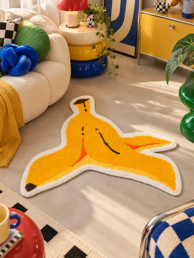 Banana peel rug on concrete floor beside stacked yellow and blue donut side tables