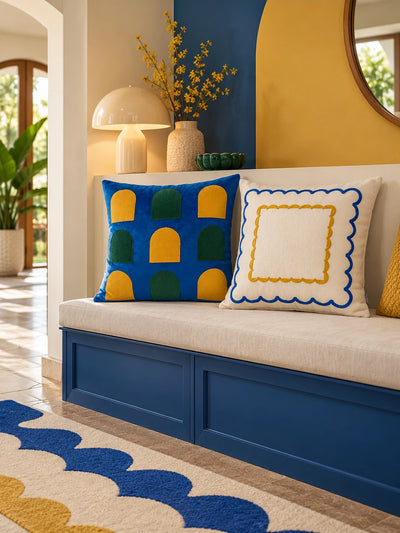 Window-arch and double scallop pillows on a cream bench with a cobalt base and a yellow arched wall