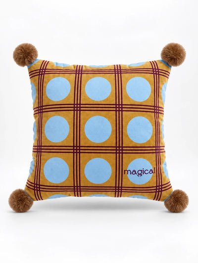 Square mustard throw pillow with light blue polka dots, a plum plaid grid and brown pompom corners