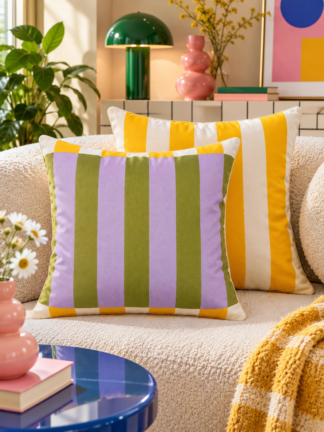 Lilac and olive striped pillow with yellow striped pillow on a cream boucle sofa