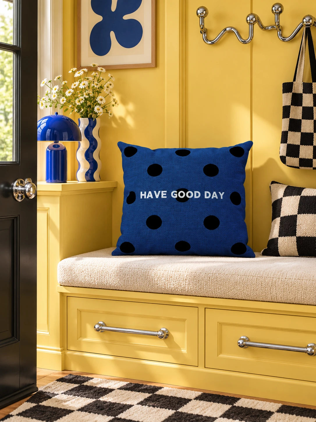 navy polka dot pillow on a yellow entryway bench with checkered accents