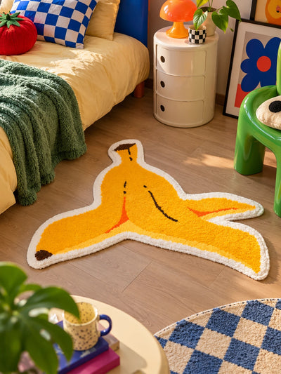 Banana peel floor mat beside a bed with yellow duvet and white round nightstand