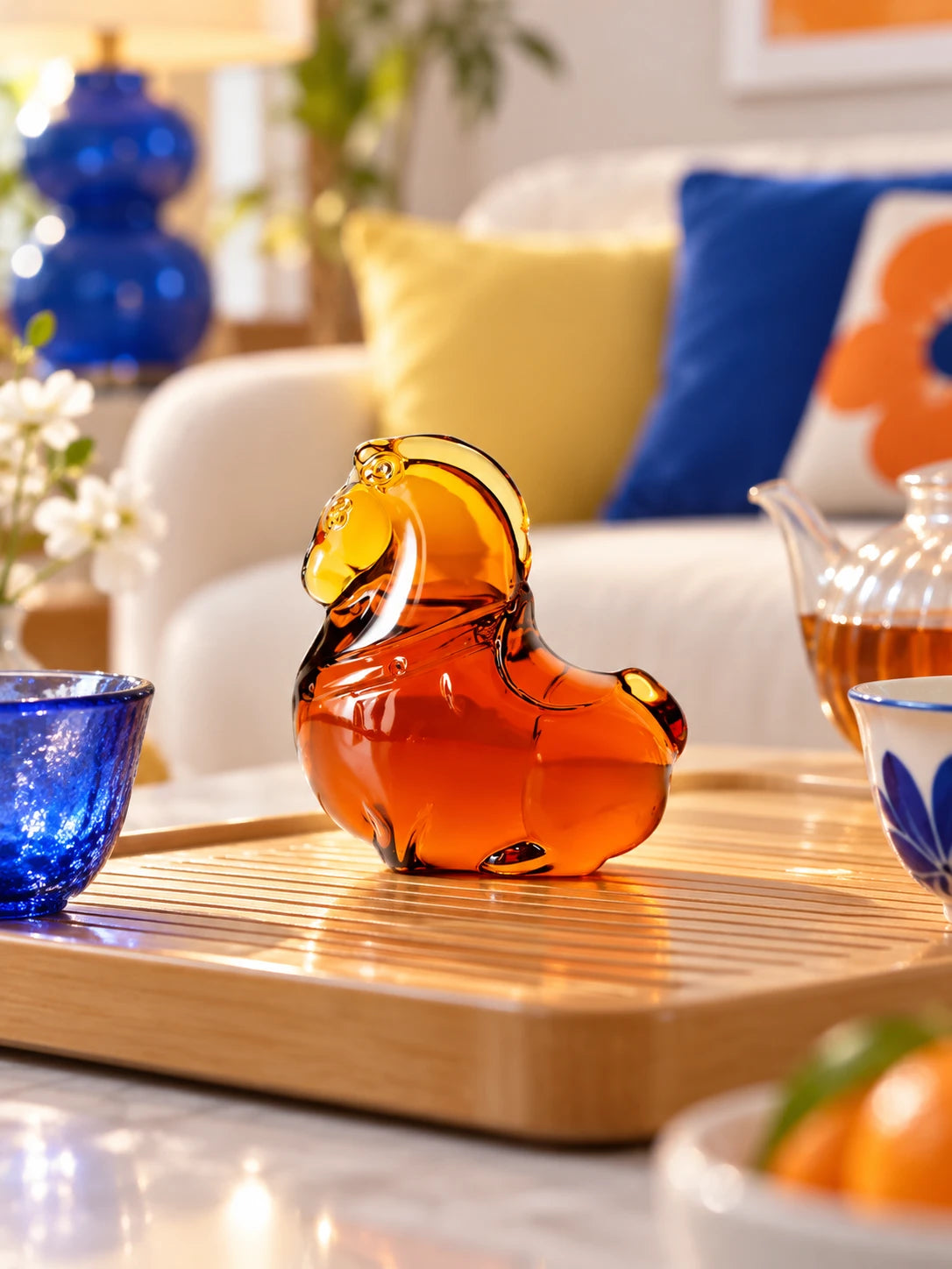 Amber glazed pony on a tea tray beside a teapot