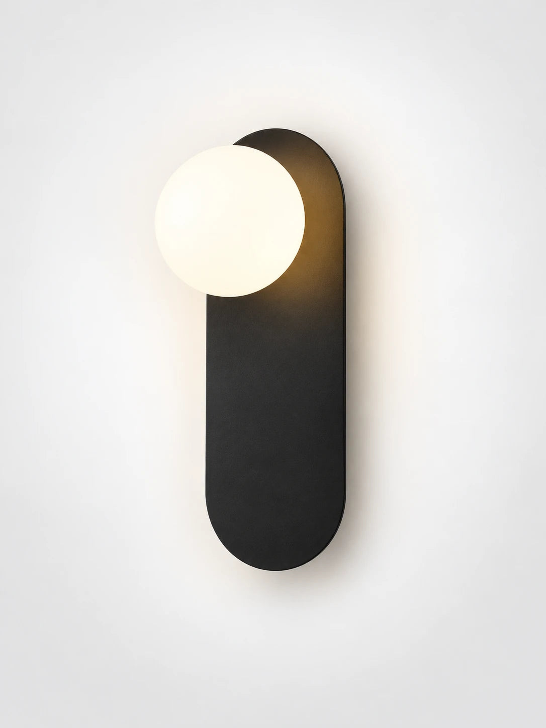 
Black minimalist wall lamp with white opal-look shade, studio shot