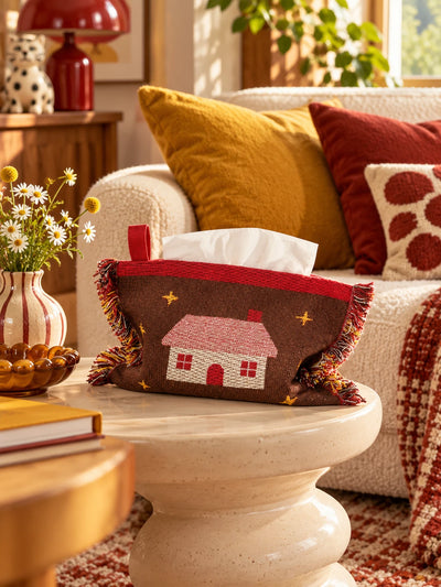 brown cabin knitted tissue pouch on a living room side table