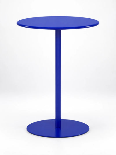 cobalt blue round pedestal side table with a flat disc base, studio shot on white