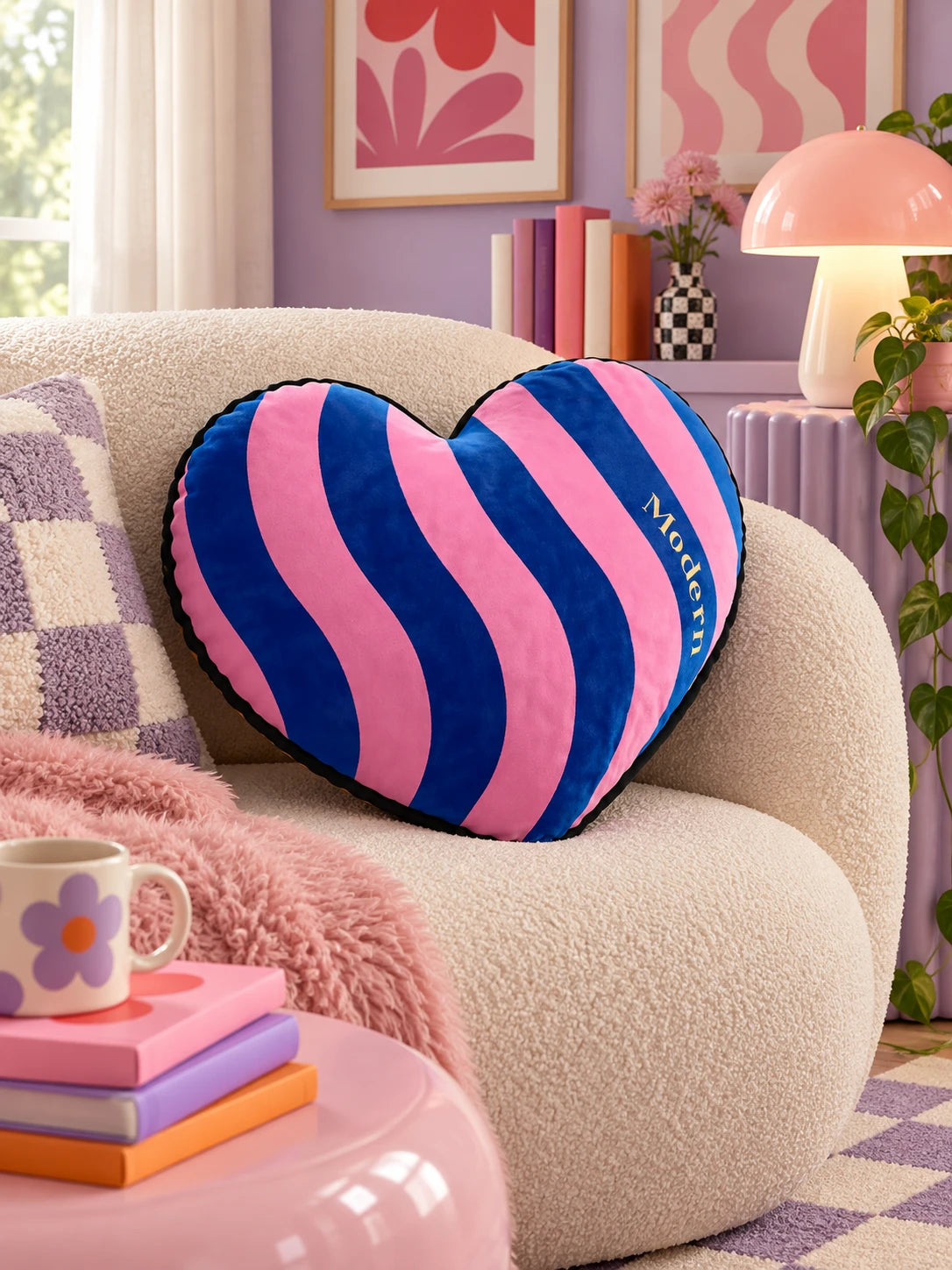 Blue and pink heart pillow on a boucle armchair in a lilac living room