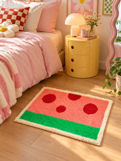 watermelon flocked mat beside a pink bed with a yellow round nightstand