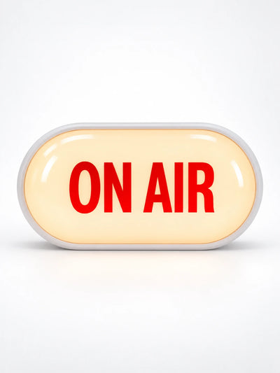 Glowing capsule ON AIR light box sign with white frame and warm lit face