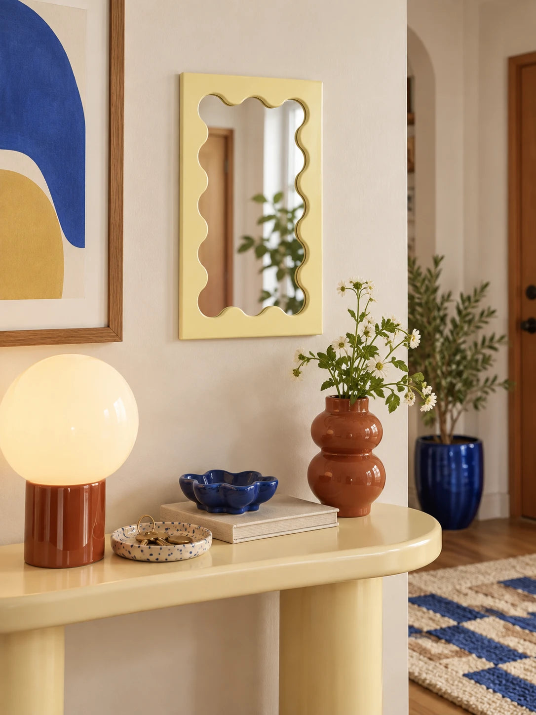 Cream wavy vanity mirror in a sunlit vanity corner with plants