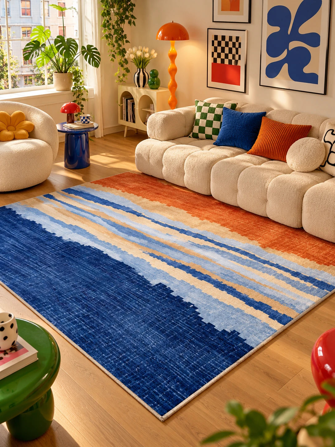 Gradient area rug in a sunlit living room with gallery wall and orange mushroom floor lamp