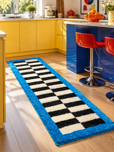 Blue border checkerboard runner along a yellow kitchen with a cobalt island and red bar stools