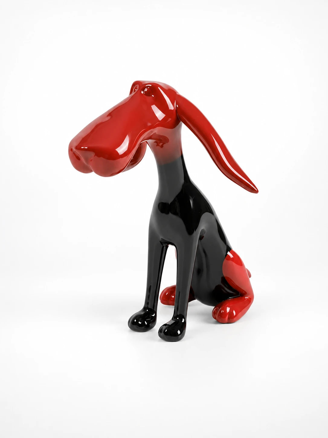 
glossy red and black cartoon dog sculpture with a long floppy ear, studio shot on white
