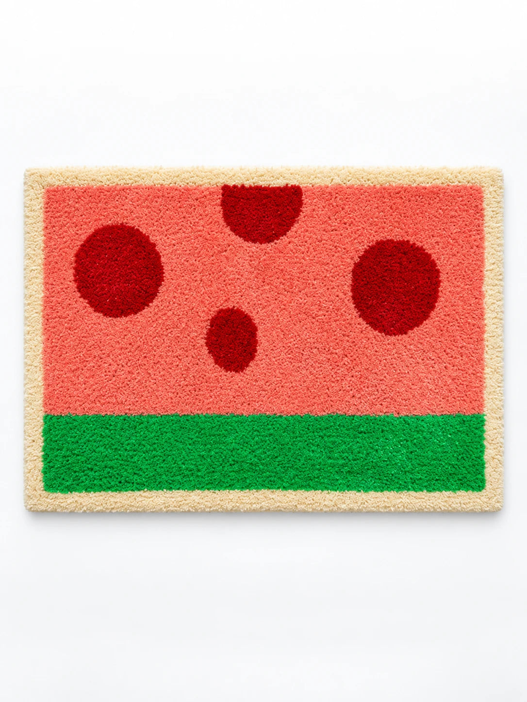 
watermelon flocked bath mat in coral pink with dark red dots, green stripe and cream border, studio view