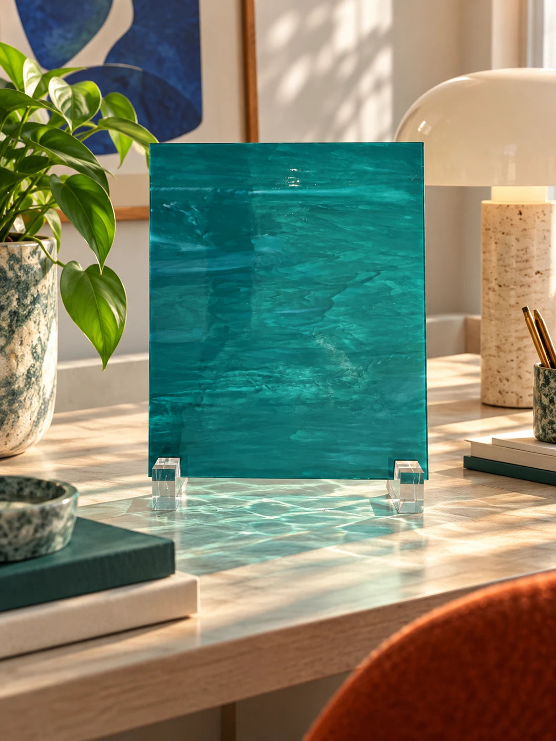 teal rippled glass sheet on a desk with a mushroom lamp and pencil cup