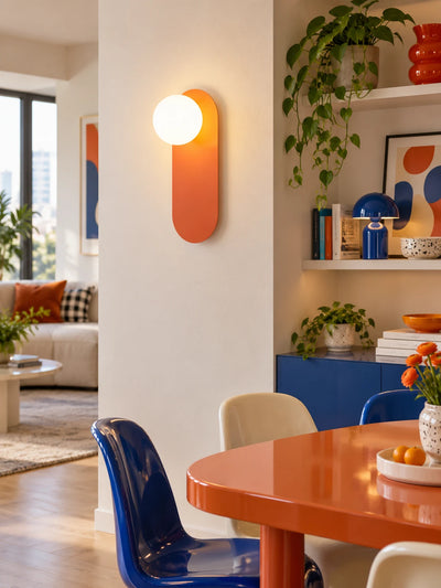 Wall lamp casting warm light in a colorful hallway corner