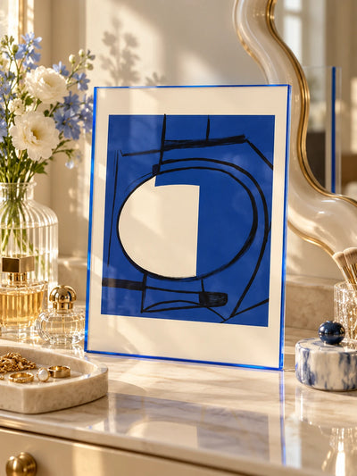 blue acrylic poster frame with ink abstract print on a marble vanity